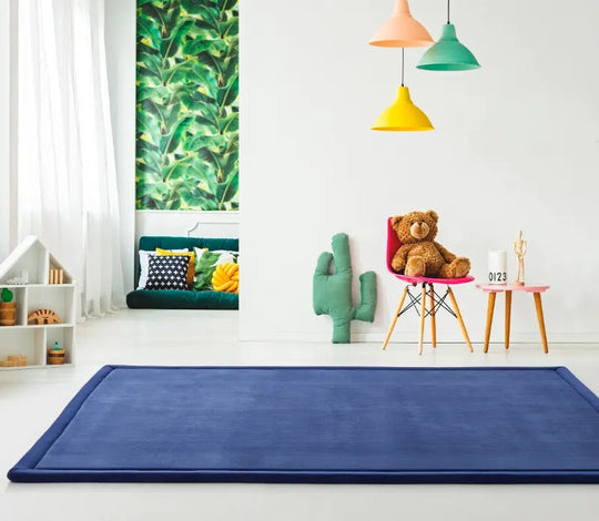 Colorful modern children's bedroom with blue area rug, pendant lights, and botanical wall decor
