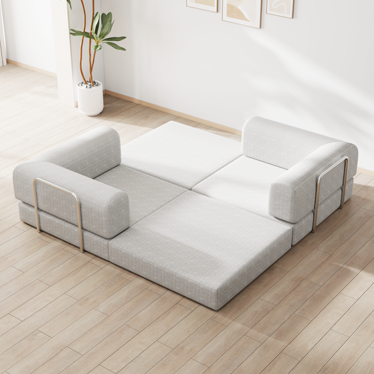 Modular gray and white fabric sofa with adjustable sections on wooden floor in minimalist living room