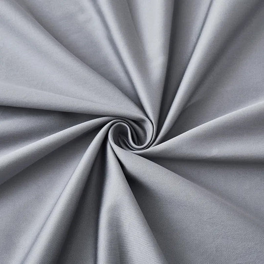 Close-up of grey cotton anti-allergy bedding fabric twisted into a swirl to show its texture
