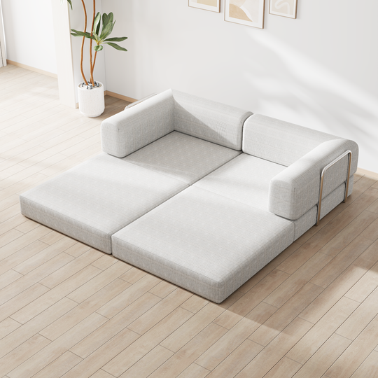 Modular sectional sofa with light gray upholstery and metal accents in minimalist living room
